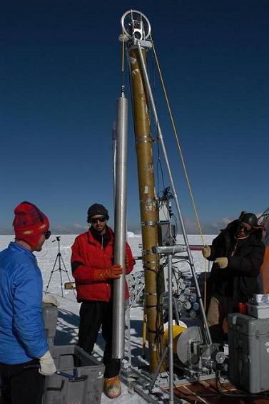 Researchers set up a large piece of equipment in the snowy landscape of  Coropuna, Peru.