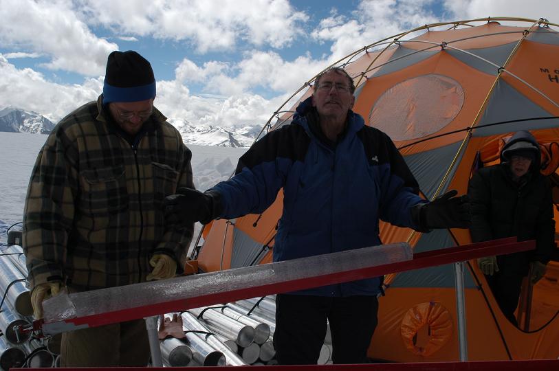 Two people working at a research site in Quelccaya, Peru. 2003. They are analyzing an ice core
