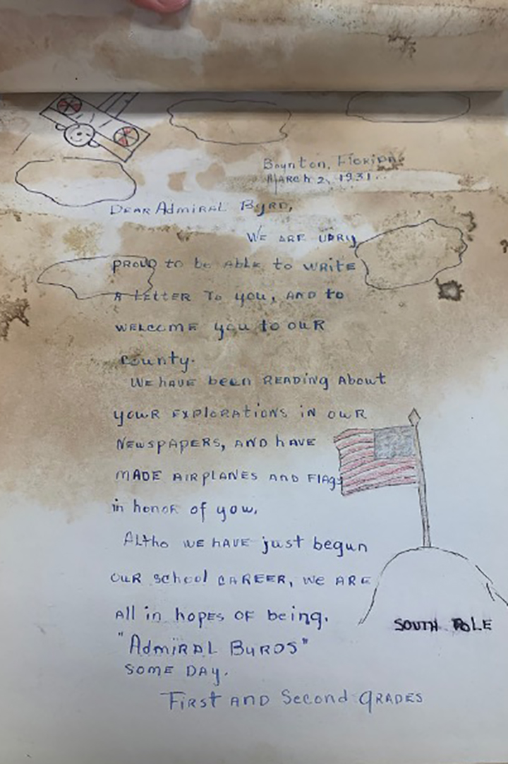 A letter from a student reading "Dear Admiral Byrd, We are very proud to be able to write a letter to you, and to welcome you to our county. We have been reading about your explorations in our newspapers, and have made airplanes and flags in honor of you. Although we have just begun our school career, we are all in hopes of being 'Admiral Byrds' one day." 
