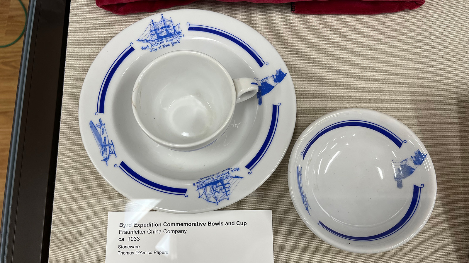 Byrd Expedition commemorative bowls and cup. They are white china with blue detail showing ships, planes, and dogs.