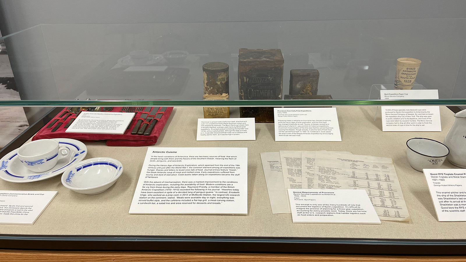 Archive exhibit showing cutlery, dishes and old food packaging.