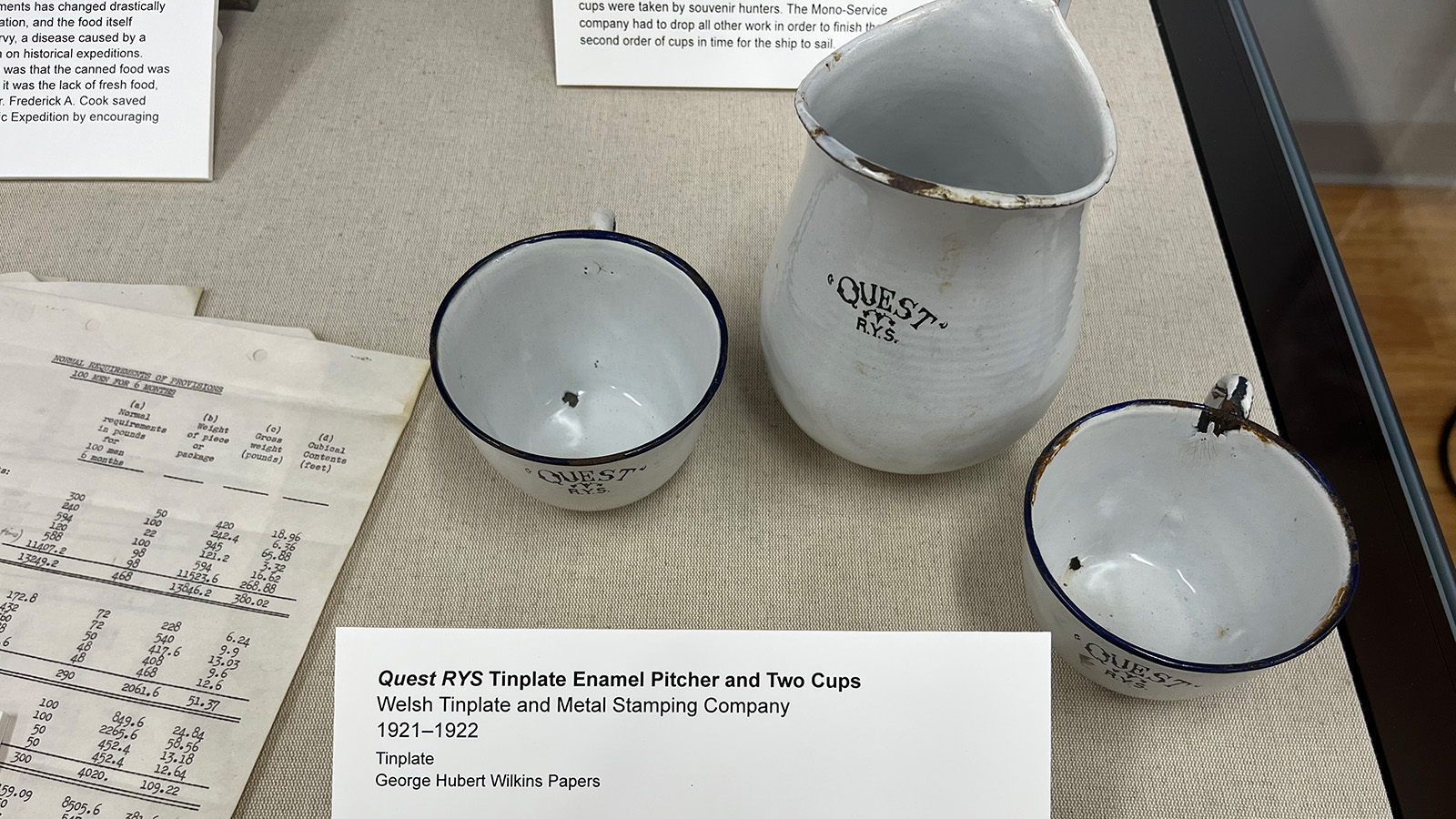 A tinplate enamel pitcher and two cups from the ship "Quest RYS."