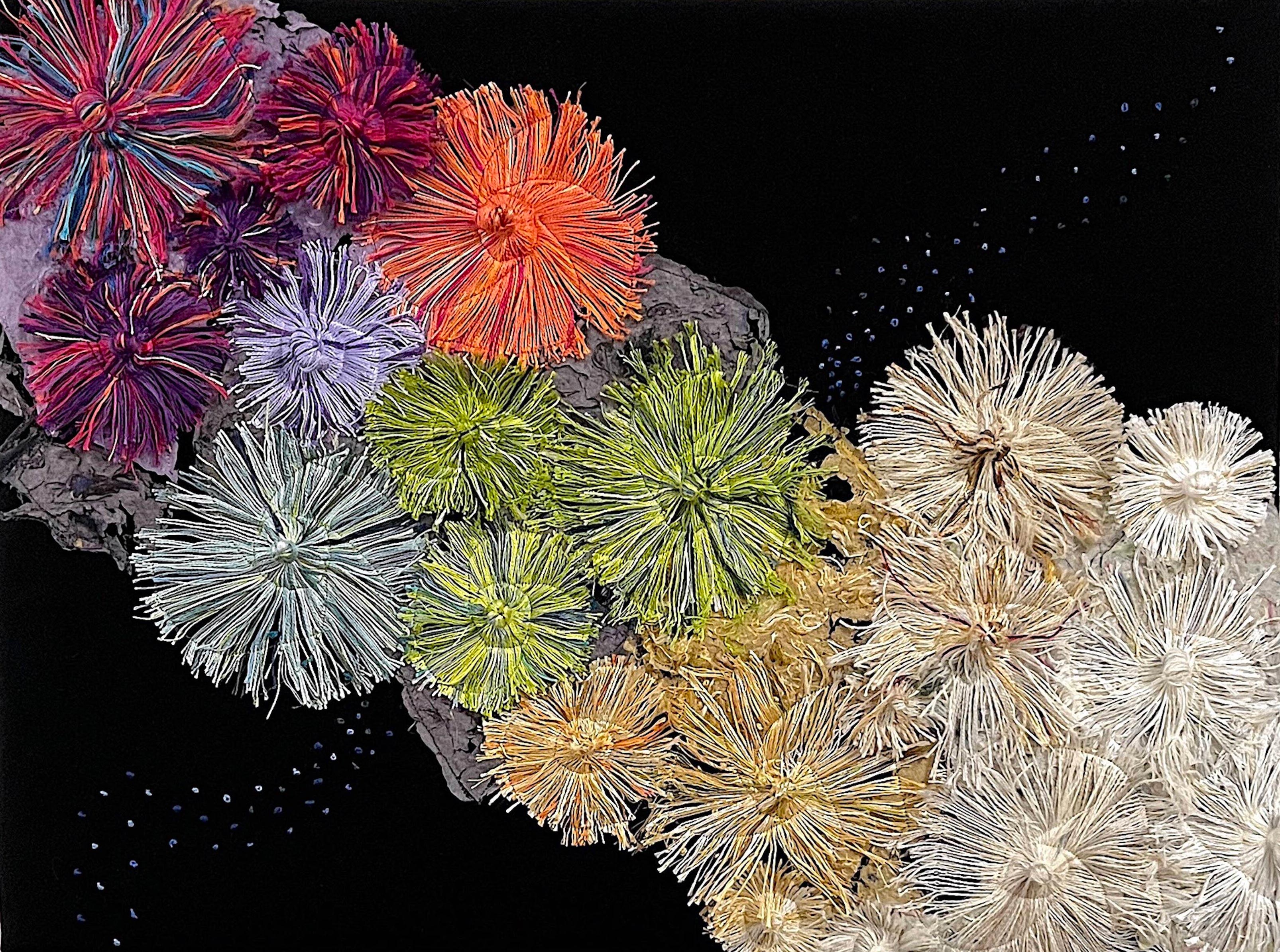 Art  handmade paper, upcycled warp yarn remnants representing Coral reef from top left to bottom right colorful coral turns to bleached coral against a black backdrop.