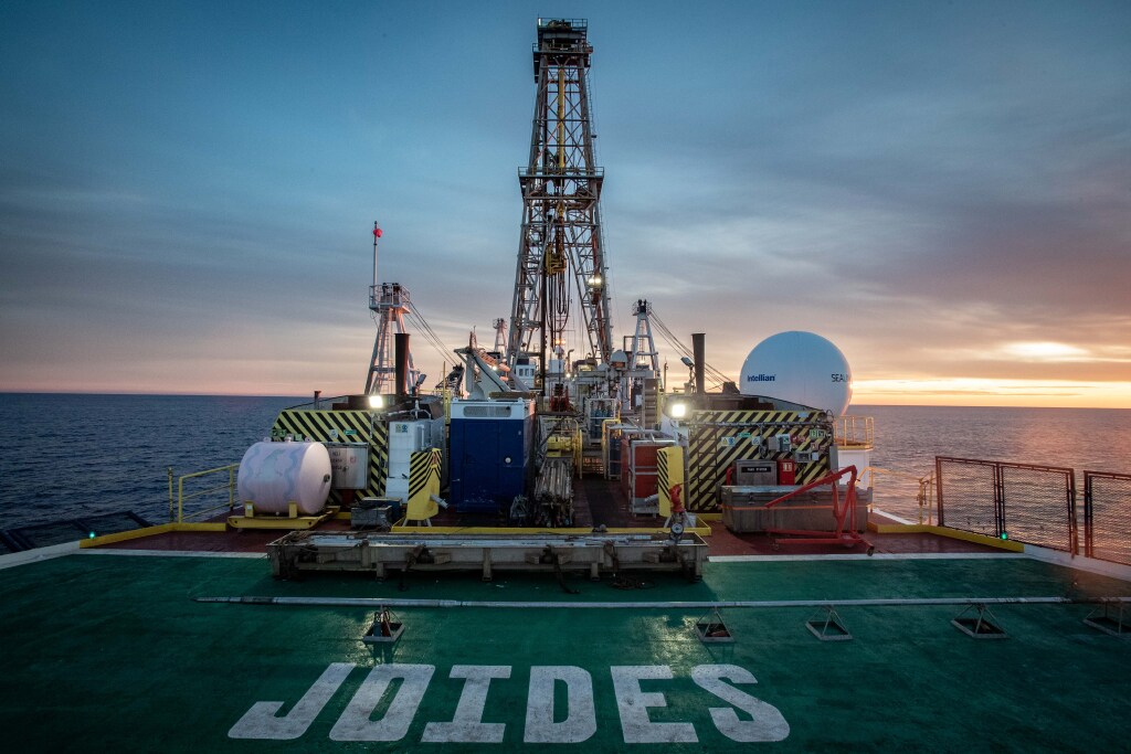 A view of the JOIDES Resolution's derrick from the helideck at sunrise.