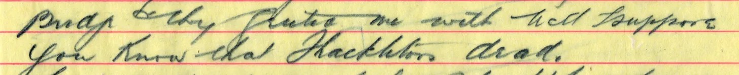 Close-up of a handwritten note on yellow lined paper.