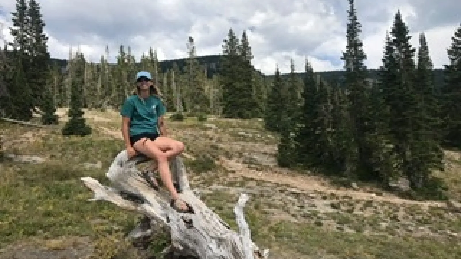 Kira Harris on a tree log