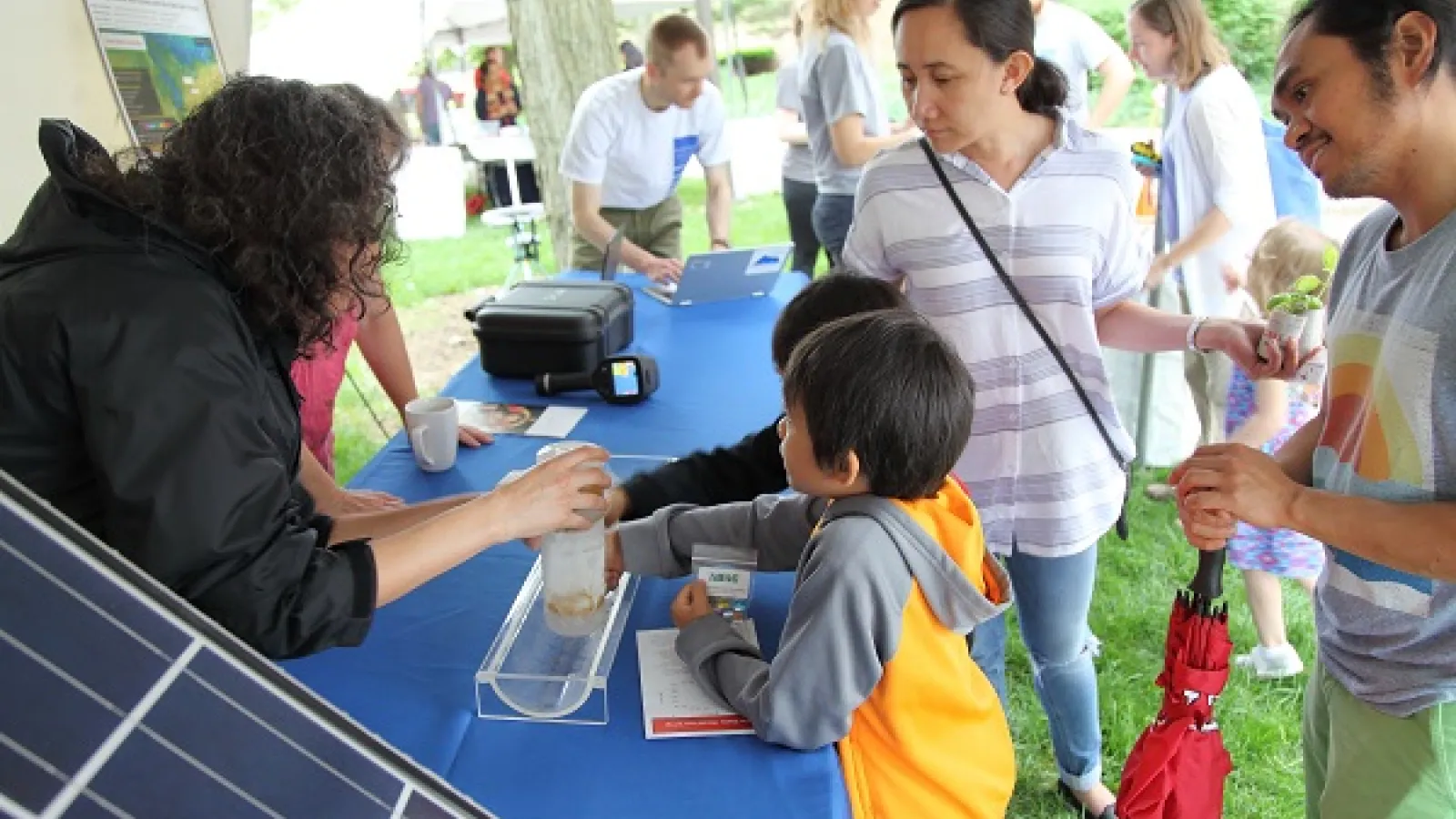 Parents look on as children learn about ice cores