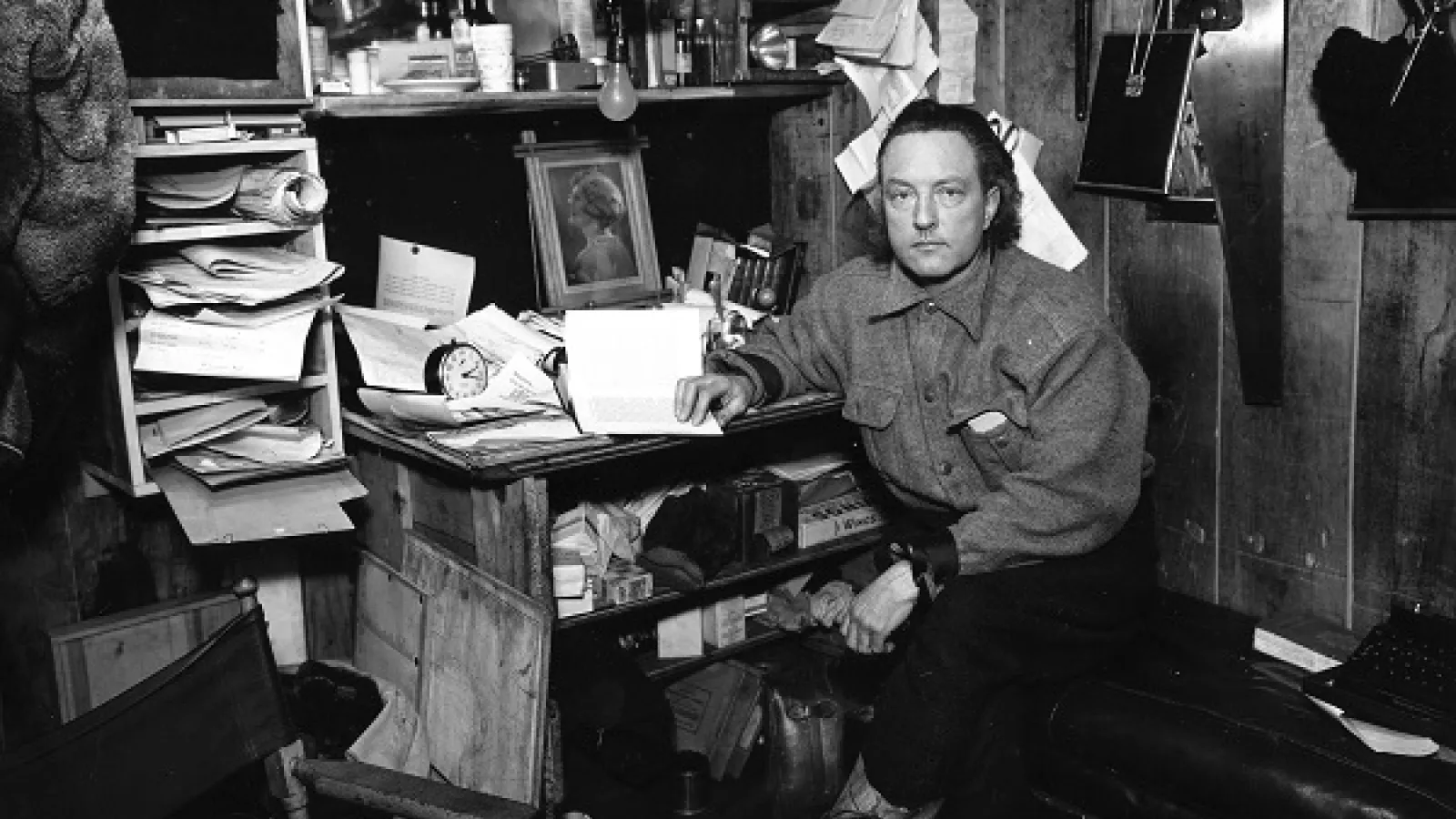 Admiral Byrd at his workstation reading a book