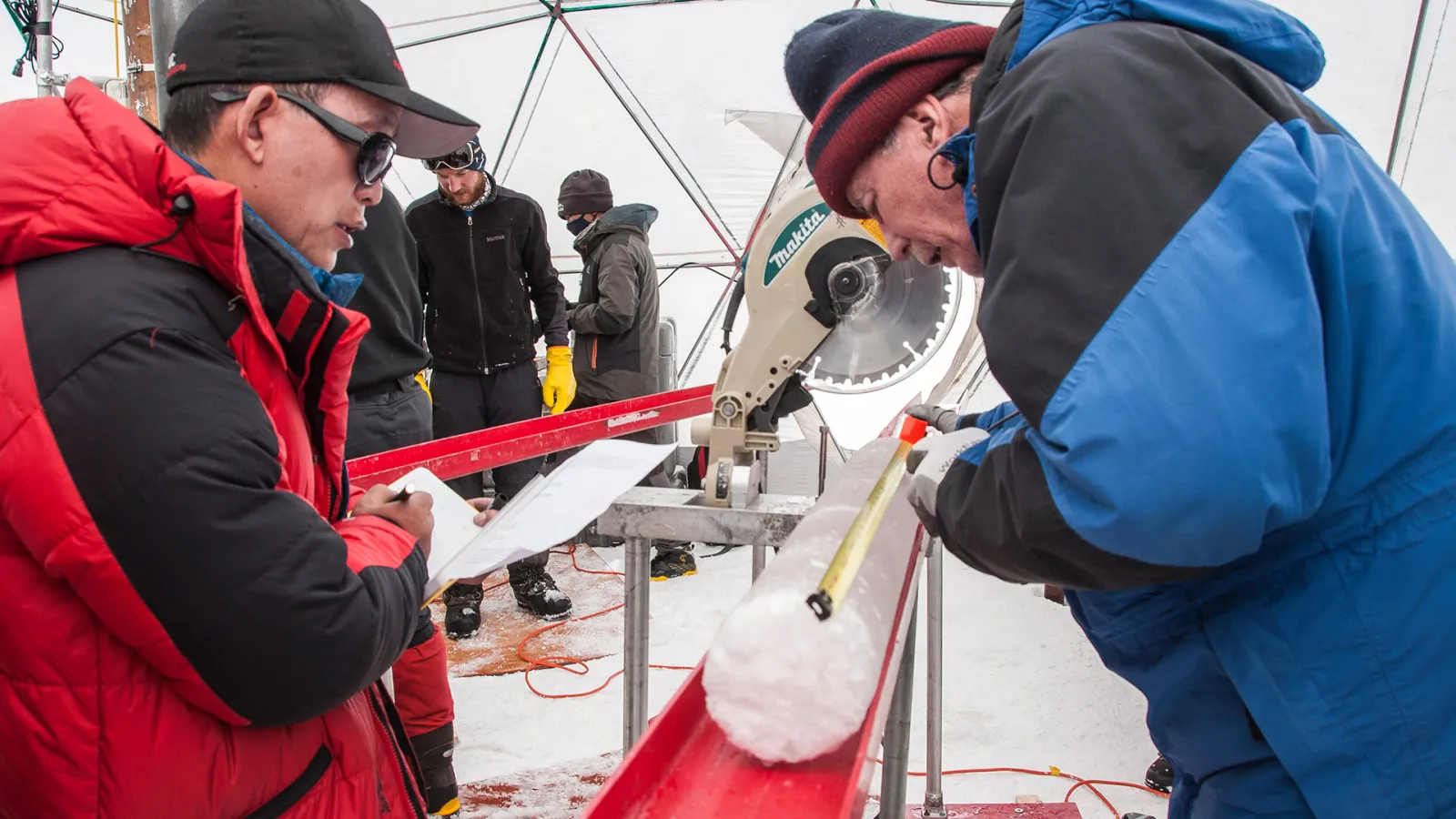 Dr. Yao and Dr. Thompson process an ice core.
