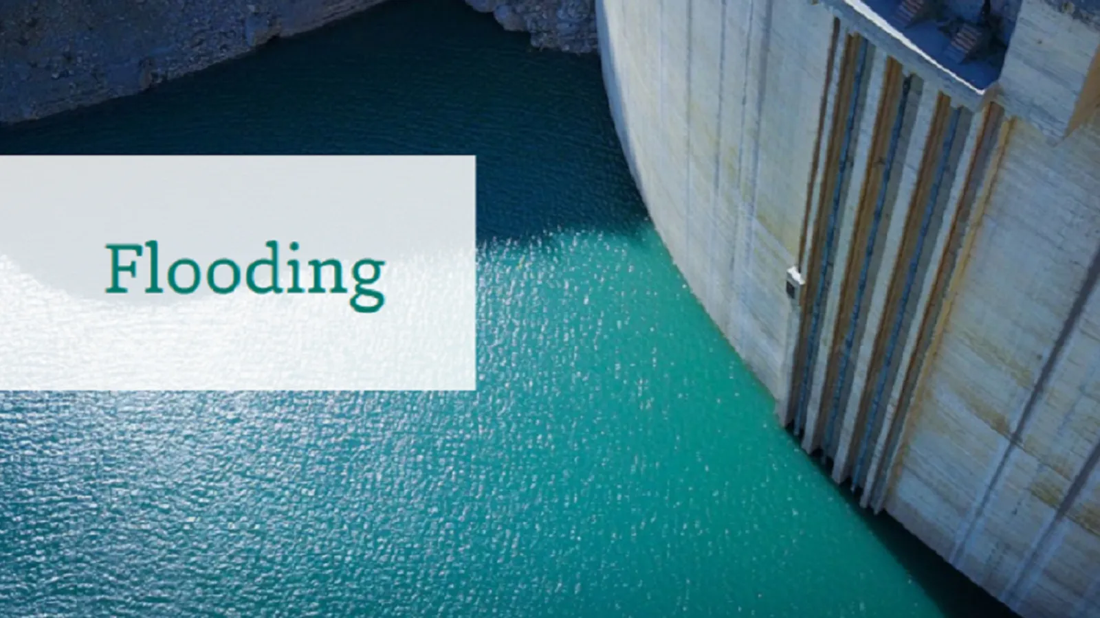 The front of a dam with the text 'Flooding'