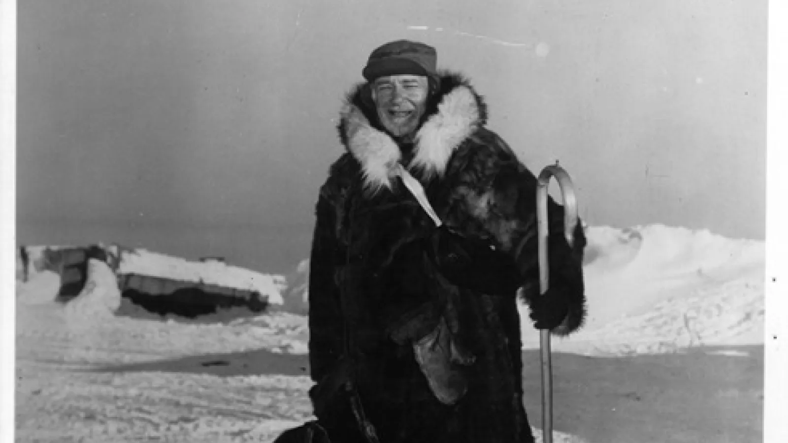 Black and white photo Hubert Wilkins standing on Ice in a thick winter coat 