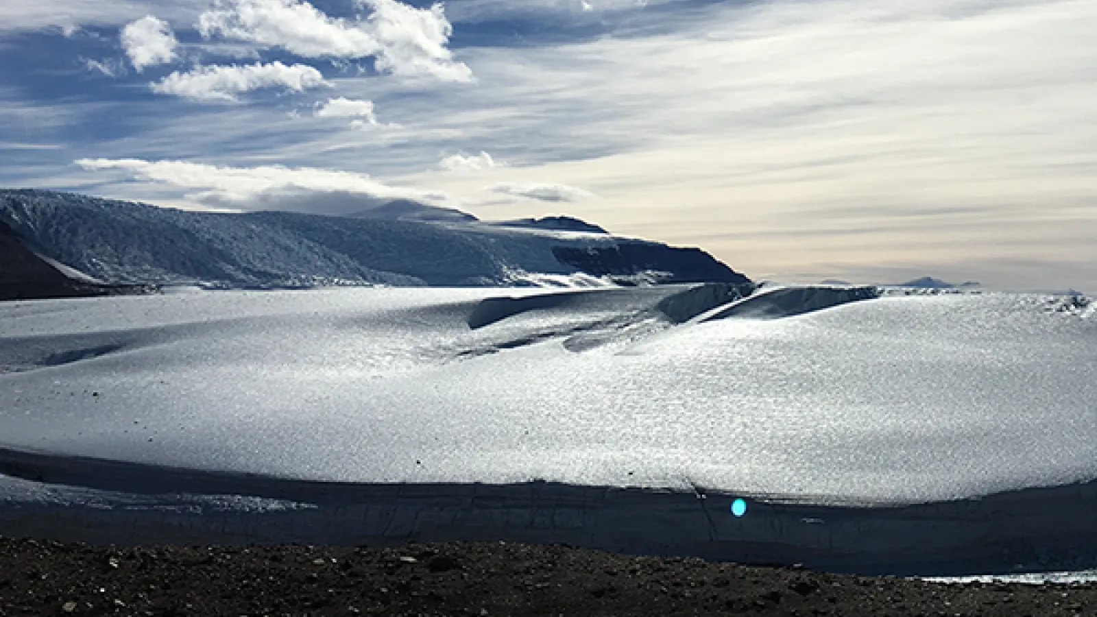 Snowy landscape with mountains in the background