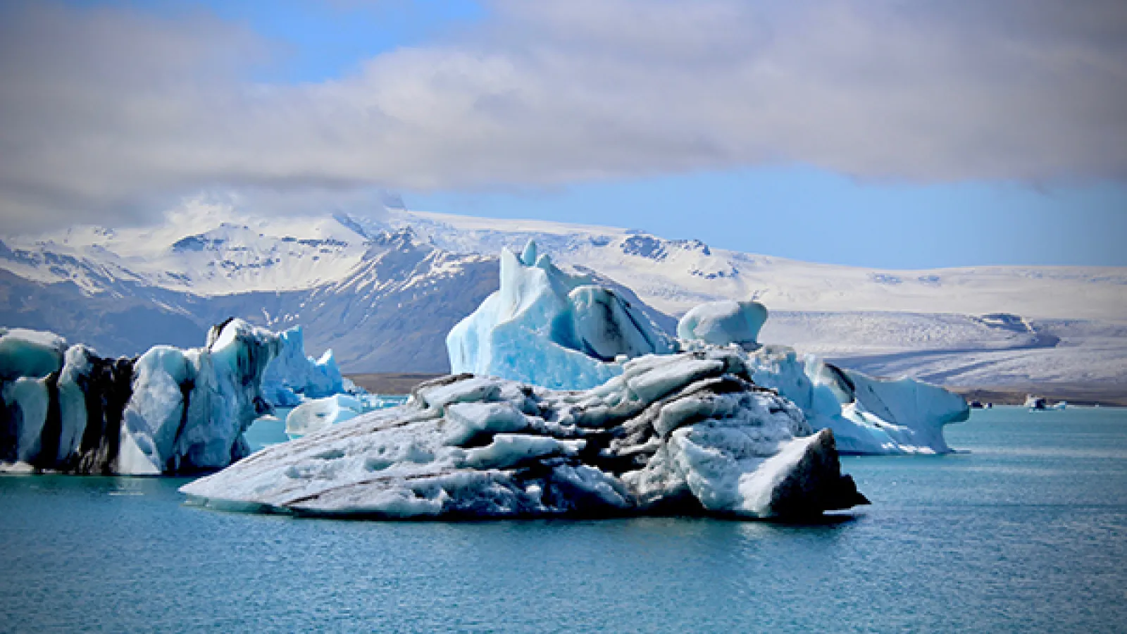 Glacier in a blue body of water 