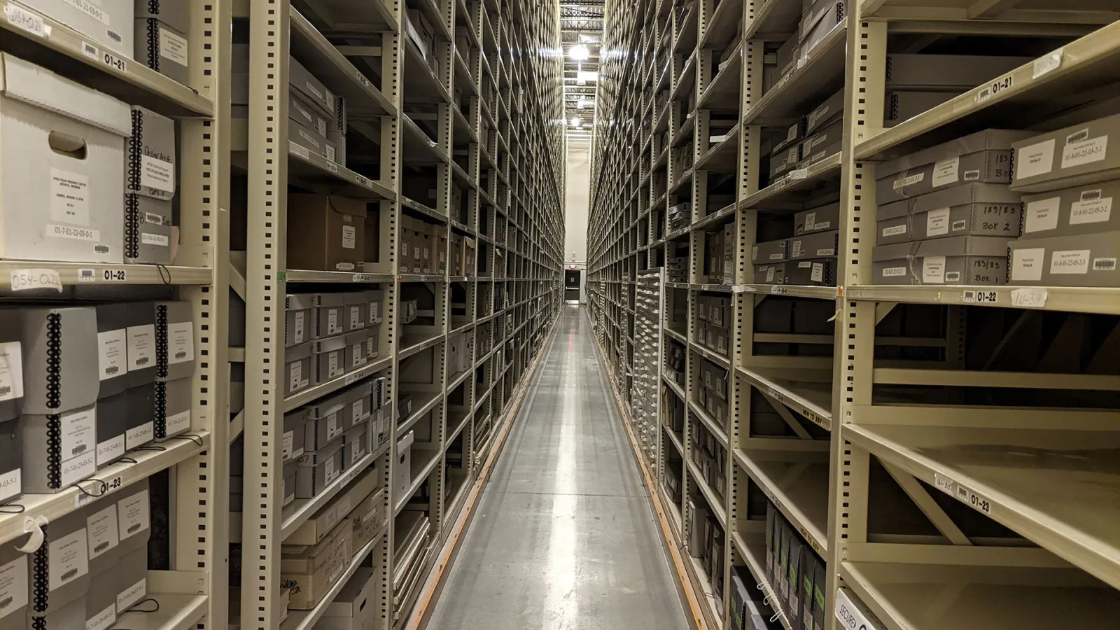 Long hallway filled with shelves of archives on both sides.