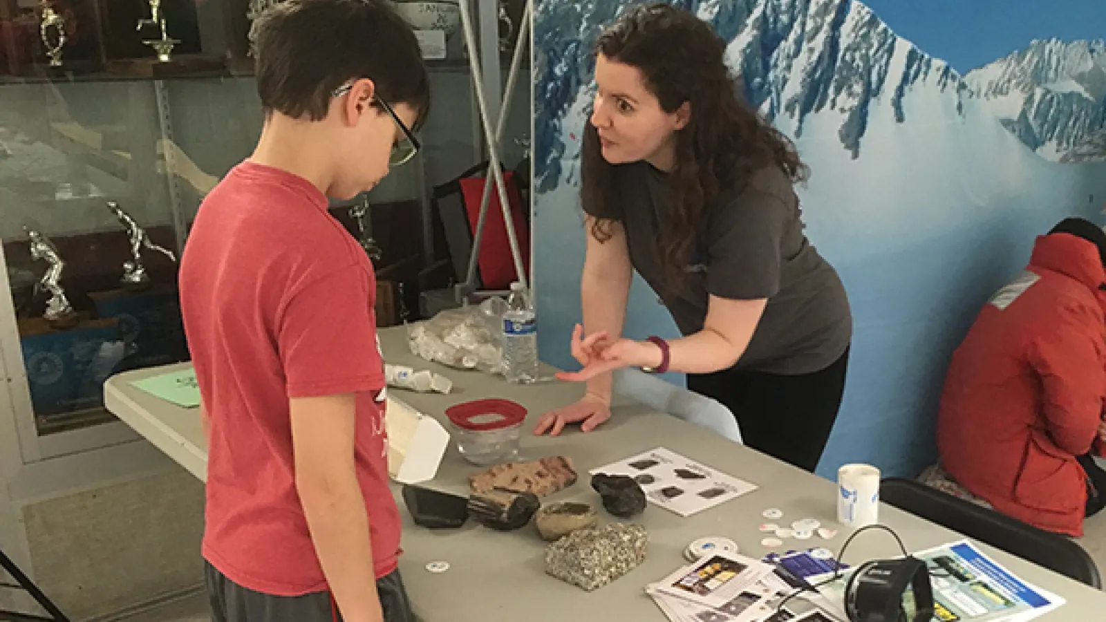 Stacy Porter working with a young boy at a table 