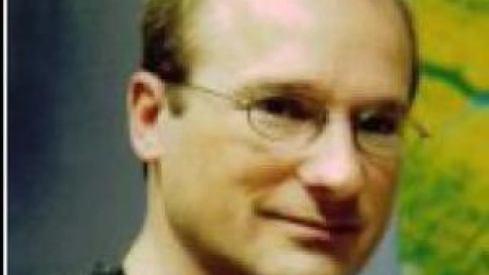 Doug Alsdorf smiling for a photo in a black sweater 