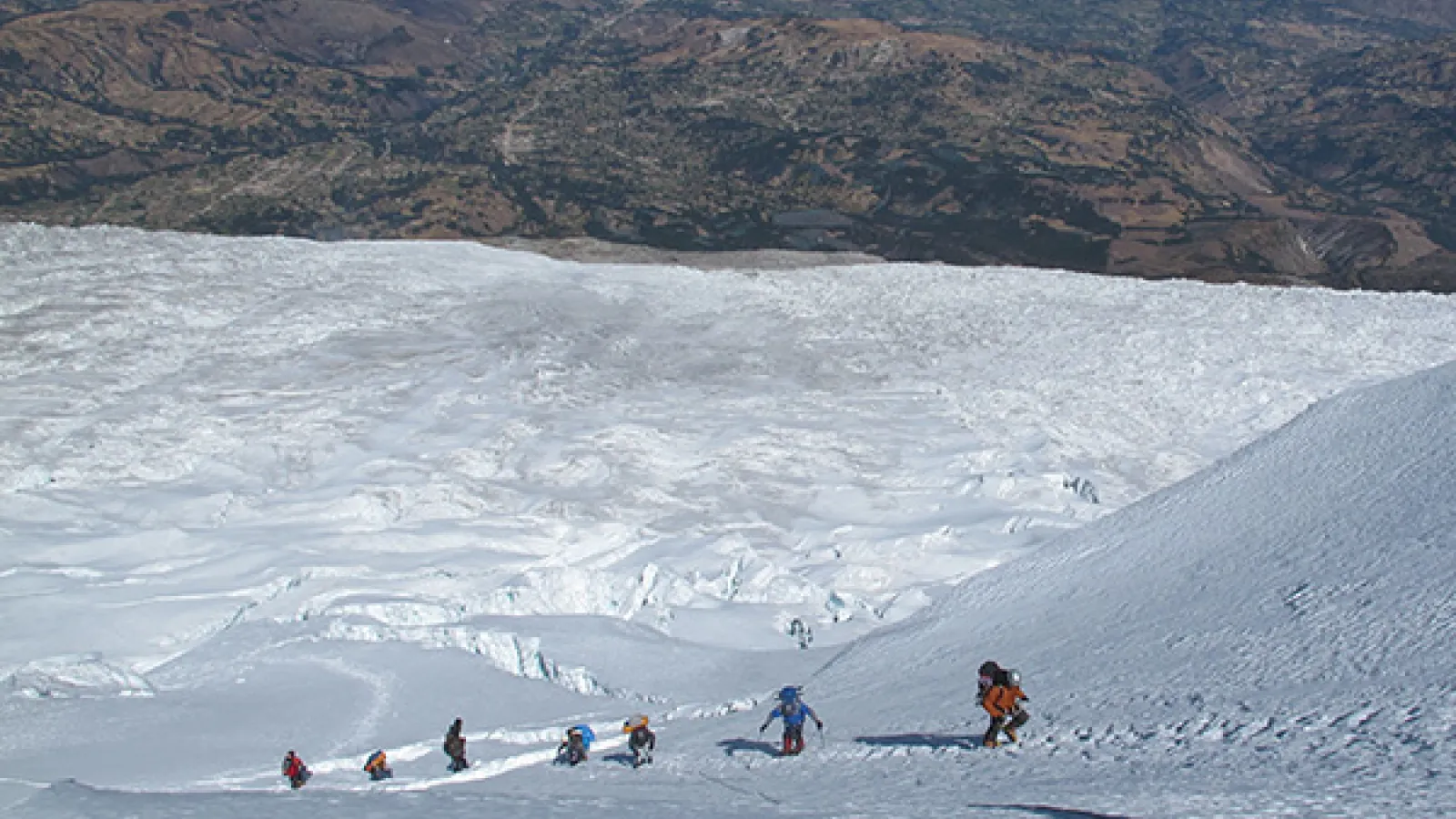 researchers climbing a snow covered scope