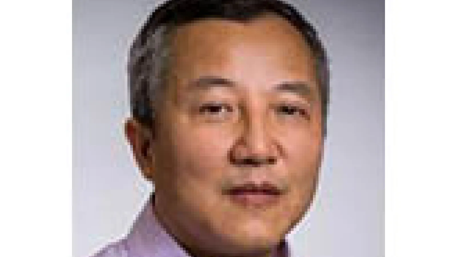portrait of Zhengyu Liu with short dark and some gray hair wearing a lavender collared shirt with a light gray background