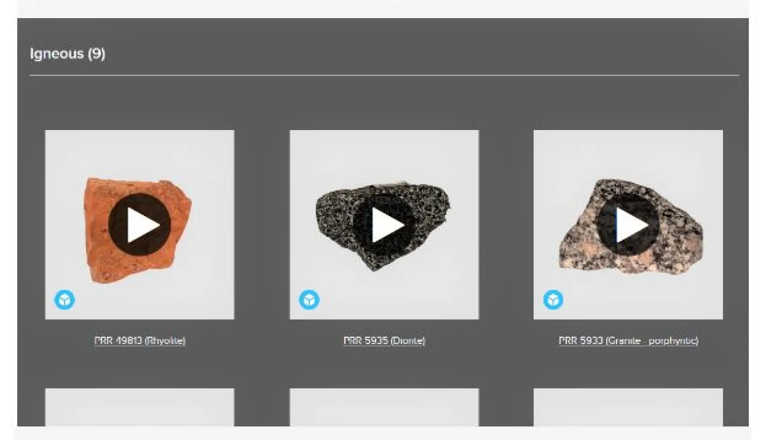 Screen showing the title of virtual Rock Box with 4 white buttons spaced out underneath it with light grey background . White boxes have writing Igneous, Sedimentary, Metamorphic and fossil. Underneath is a dark grey background with Igneous(9) written in white text as if selected then under that   with three rocks each in it's own square white box and a play button on each, showing it is an interactive page.