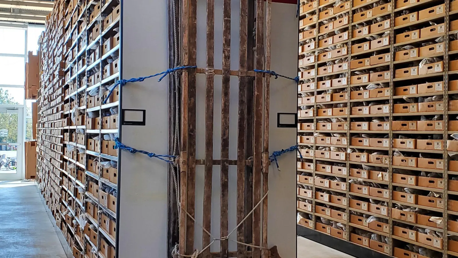 Sled on display in front of rock shelving