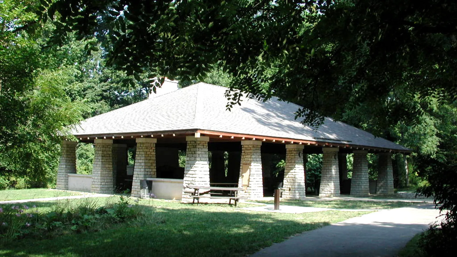 Mansion Shelter at Highbanks Metropark, a stone pavilion surrounded by green grass and trees