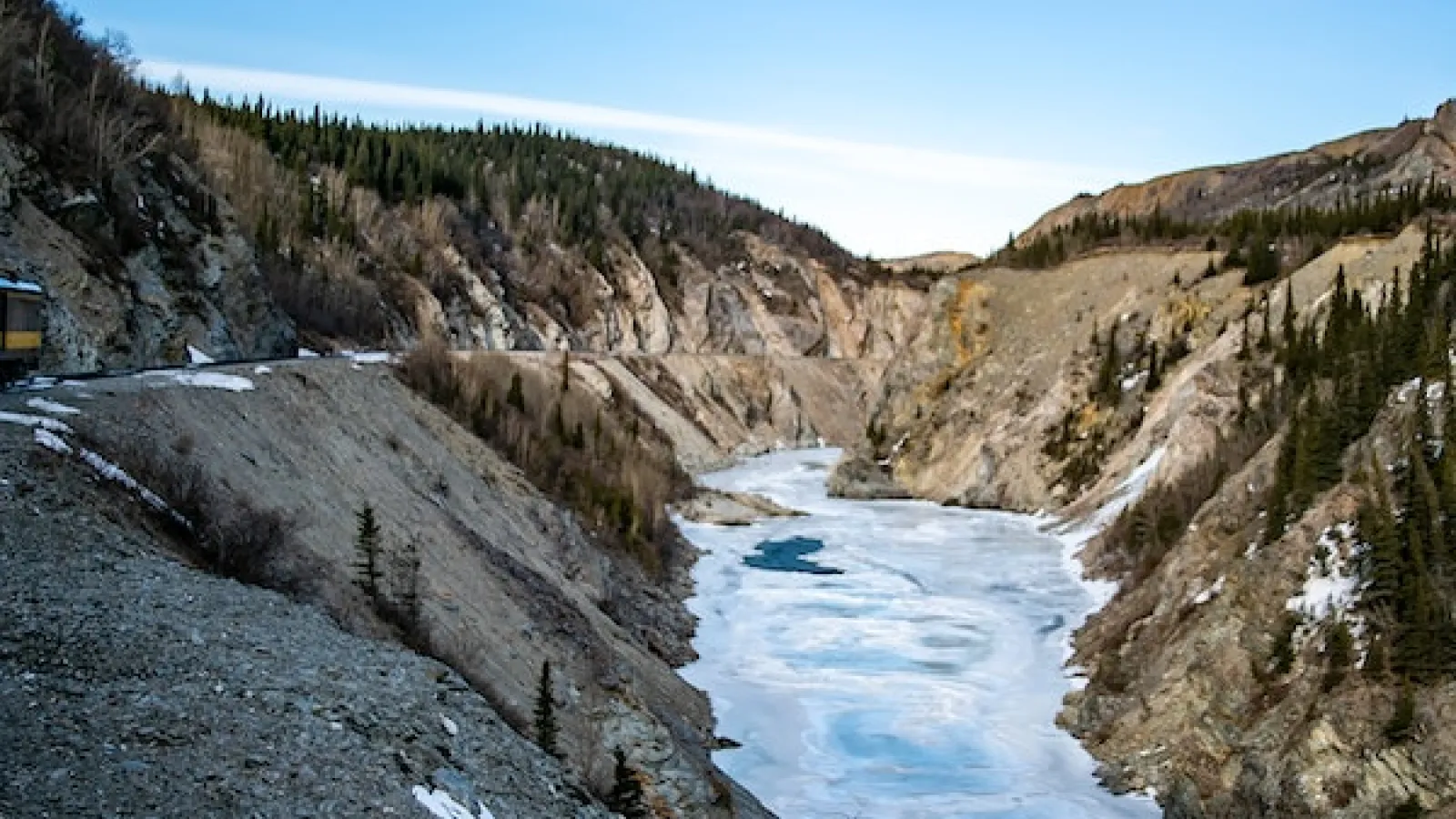 frozen river in a flanked by high rocky cliffs.