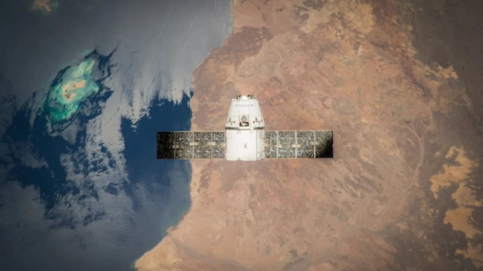 aerial view of satellite over brown earth and blue water 
