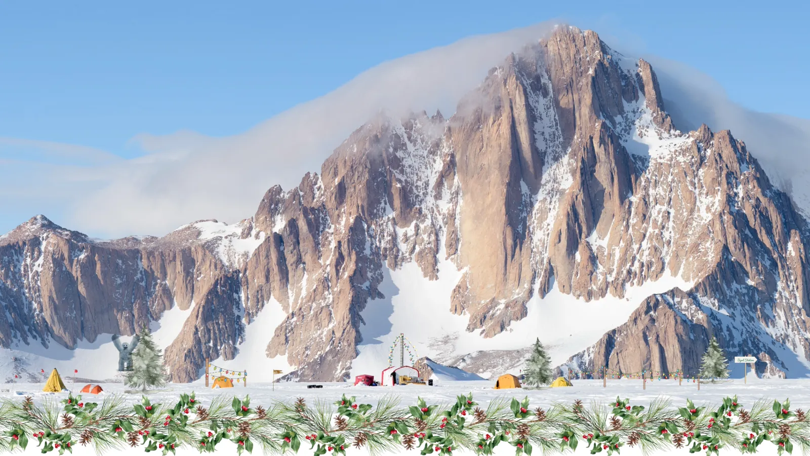 The Byrd Center Holiday card: an image of a mountain covered with snow with trees and tents at the base under blue sky and white clouds with a bow at the top left edge of the framed image with garland at bottom, under the image. 
