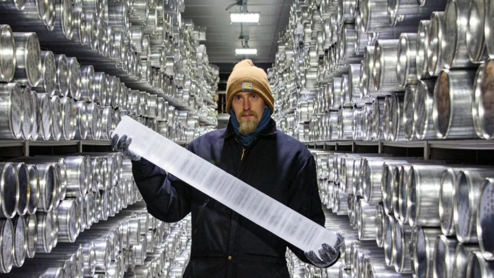 A man in winter gear standing in an indoor facility holding an ice core with text and NSF and US SCAR.logo: text says Live: What Polar ice cores tell us about our climate When: Thursday, January 18, 2024 More information and registration: https://bit.ly/icf-social