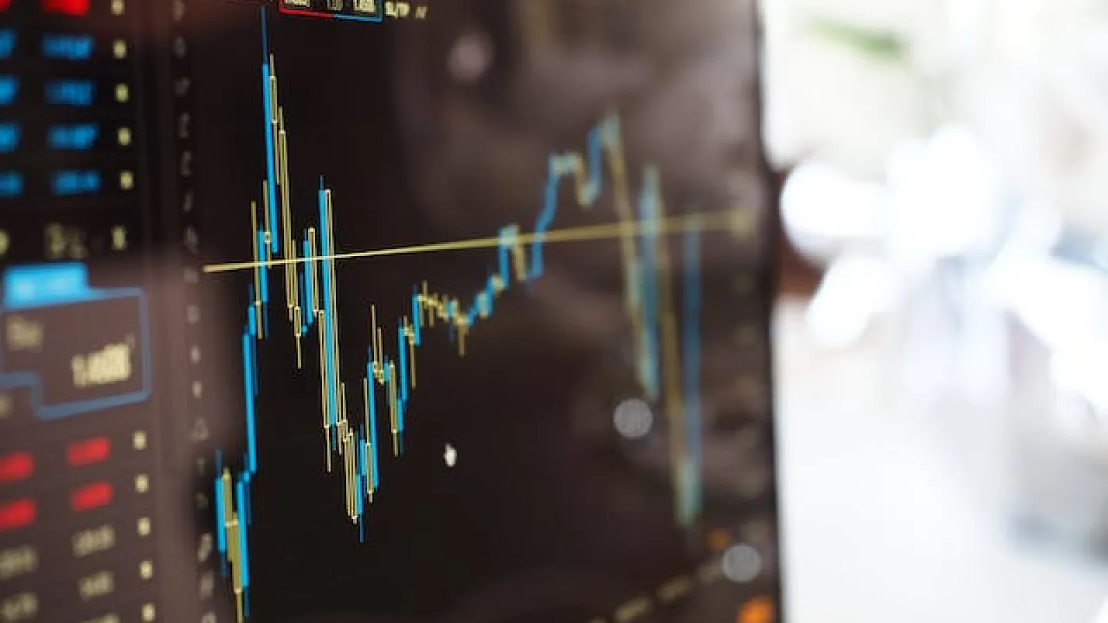 Close-up Photo of Monitor with stock chart on it.