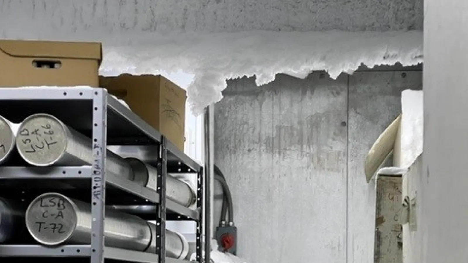 Frost covering a ceiling beam with ice cores stored beneath