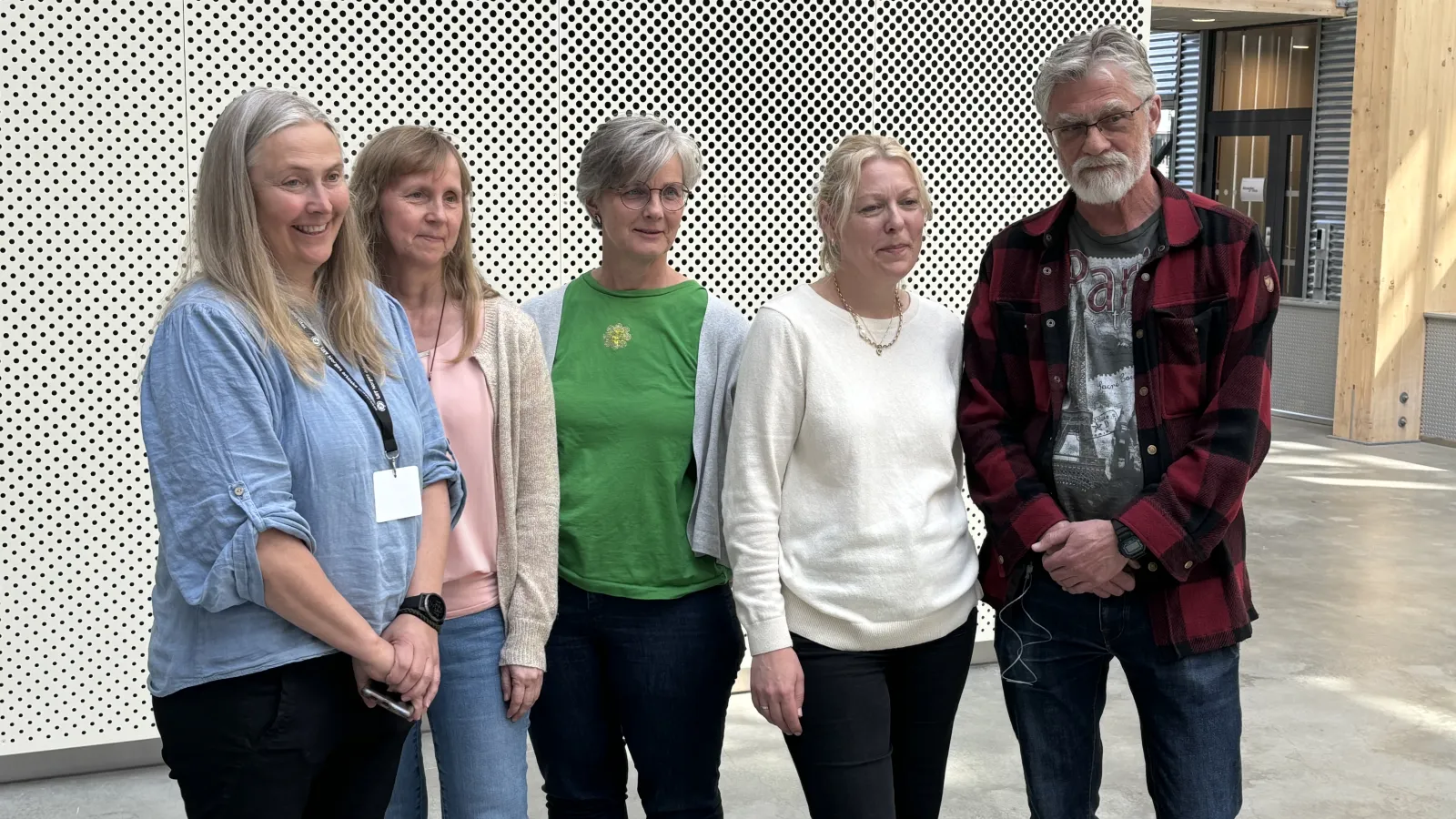 Five people posing for a photo.