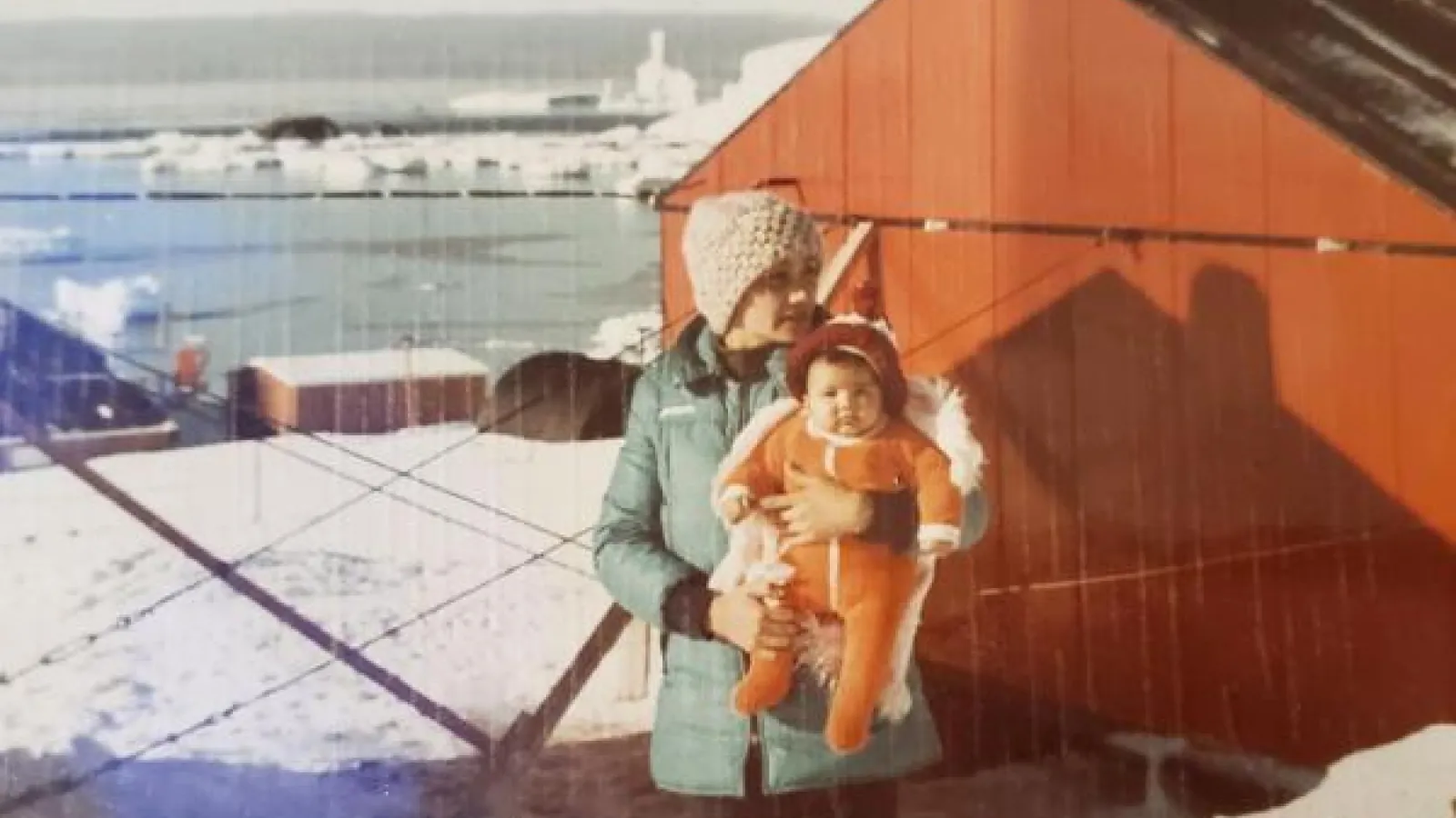 Portrait of a women holding a baby in the Antartic