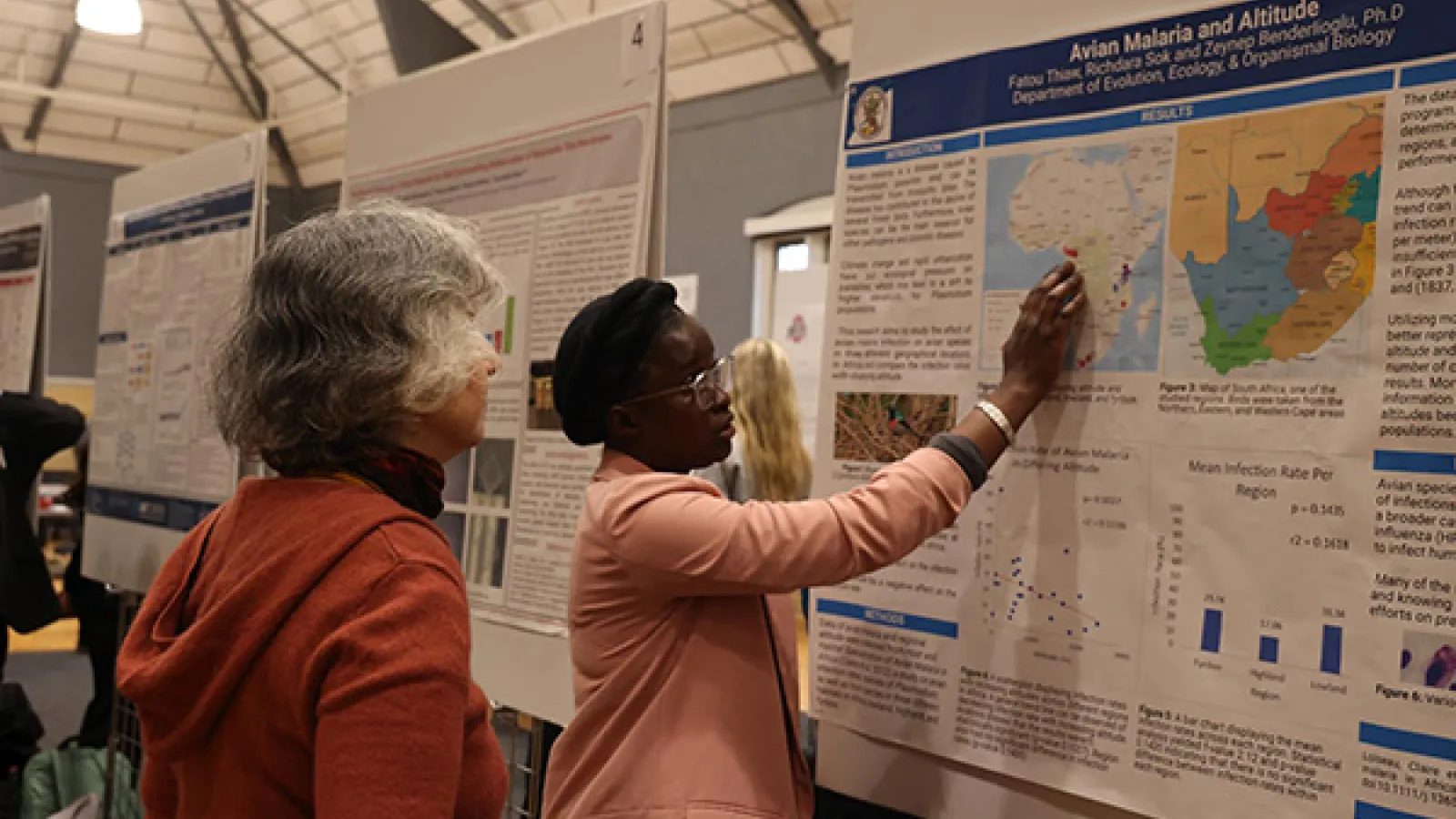 An undergraduate student presenting her research poster.