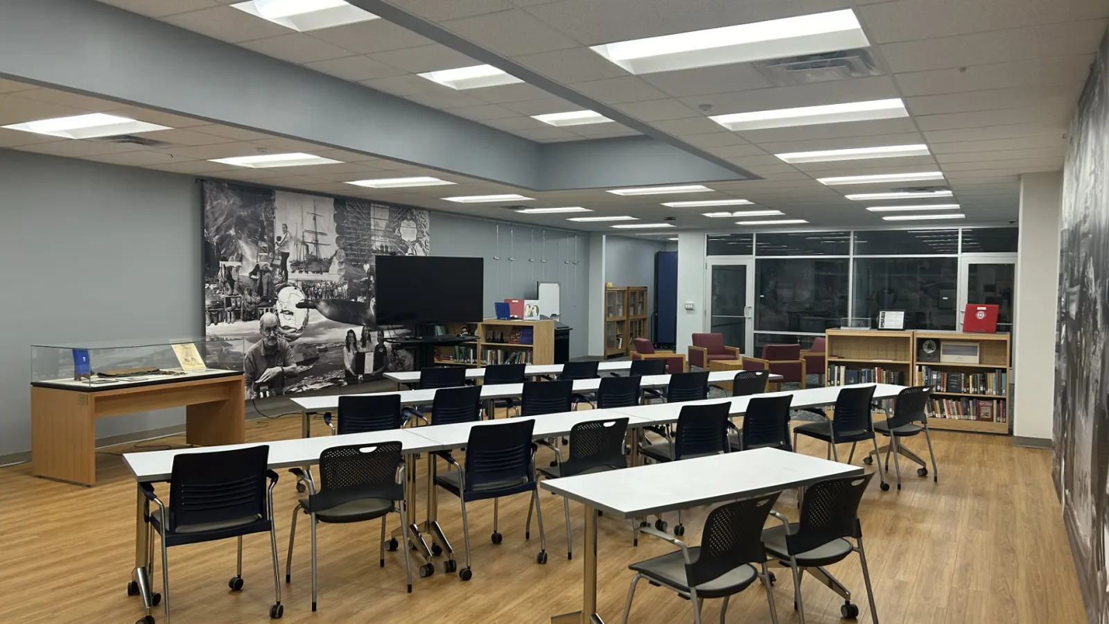 A room with a classroom layout facing a flatscreen TV. See caption for details.