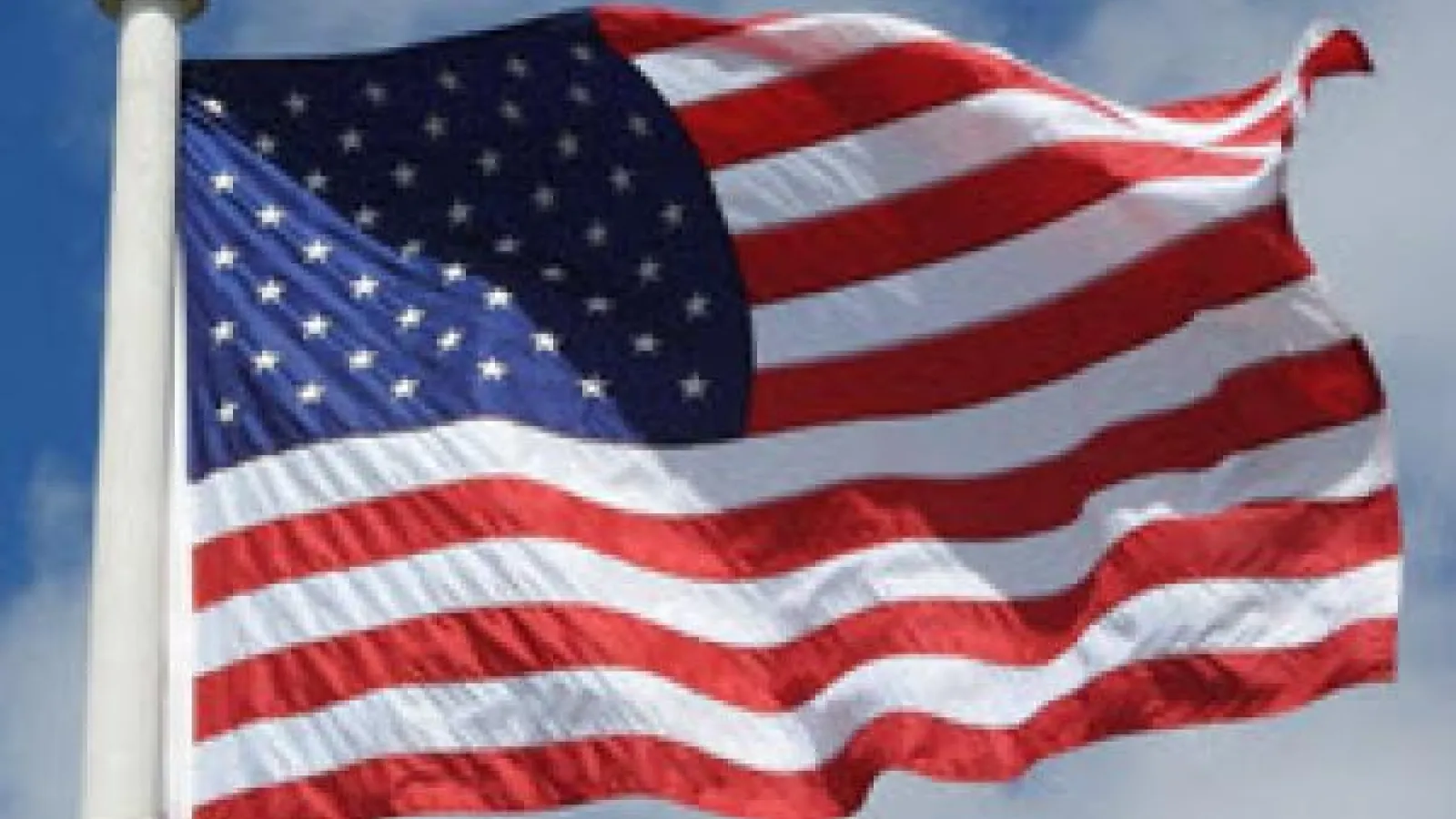 American flag attached to a pole blowing in the wind