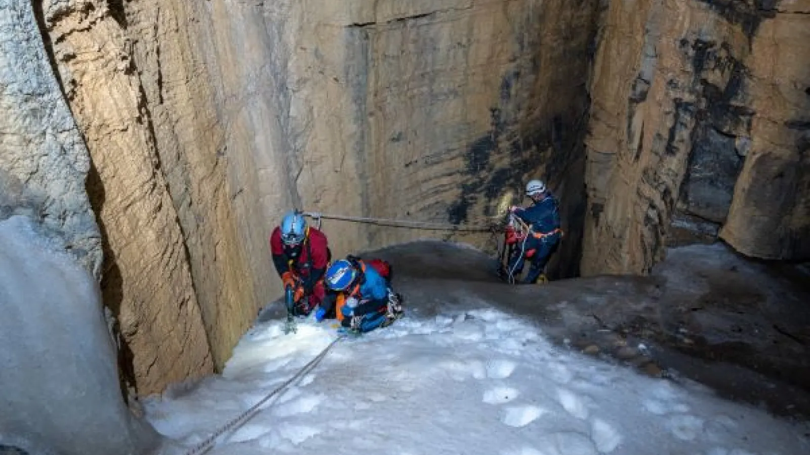 Researchers collect an ice sample in a cave in Great Basin National Park.