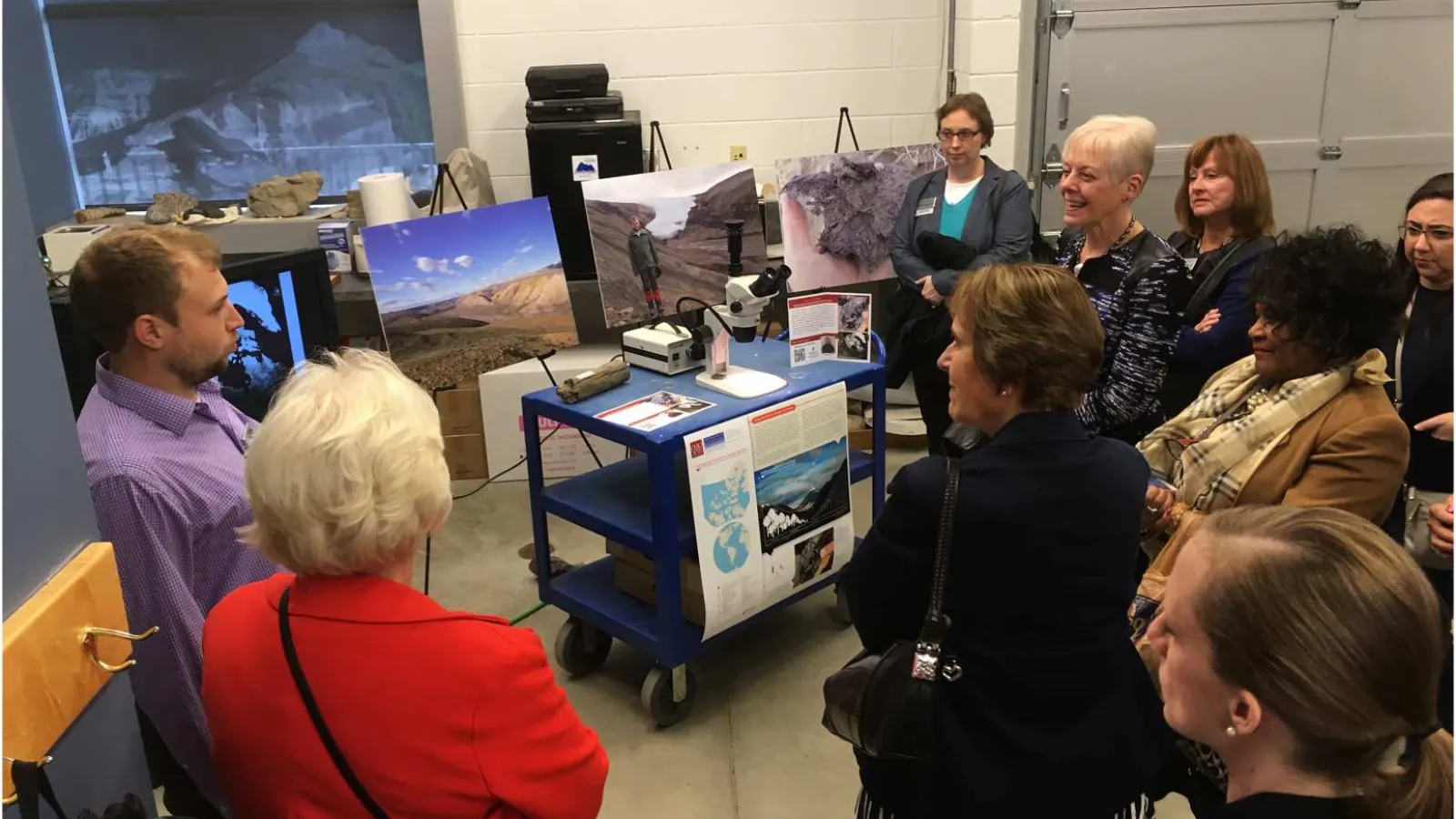 A group standing indoors for a tour.
