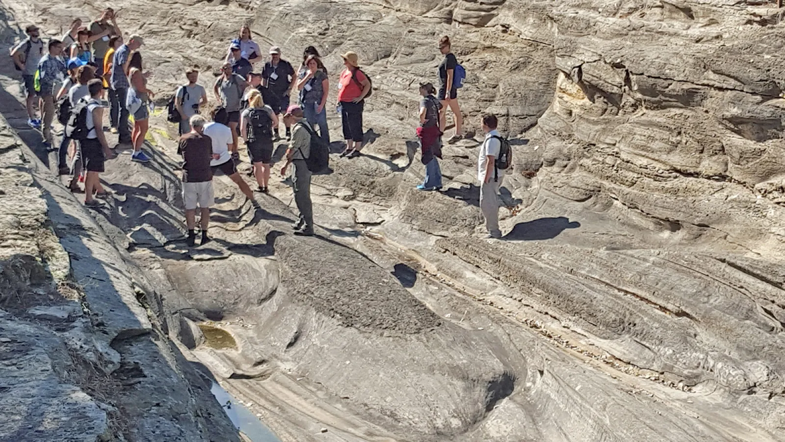 A group of people standing on a Rock formation