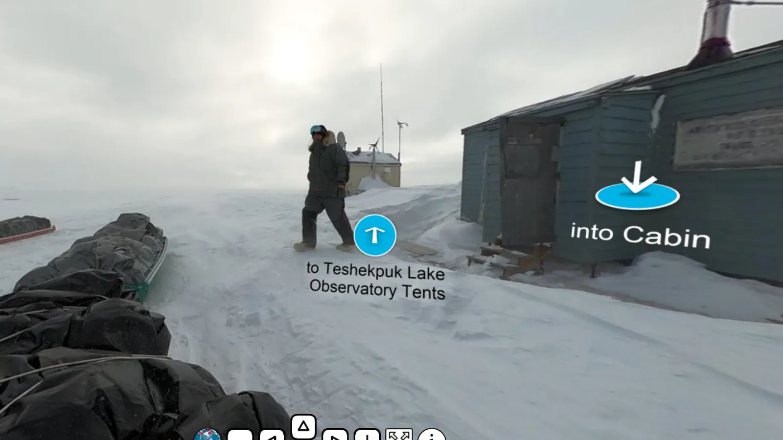 researcher walks from cabin to snowmobile