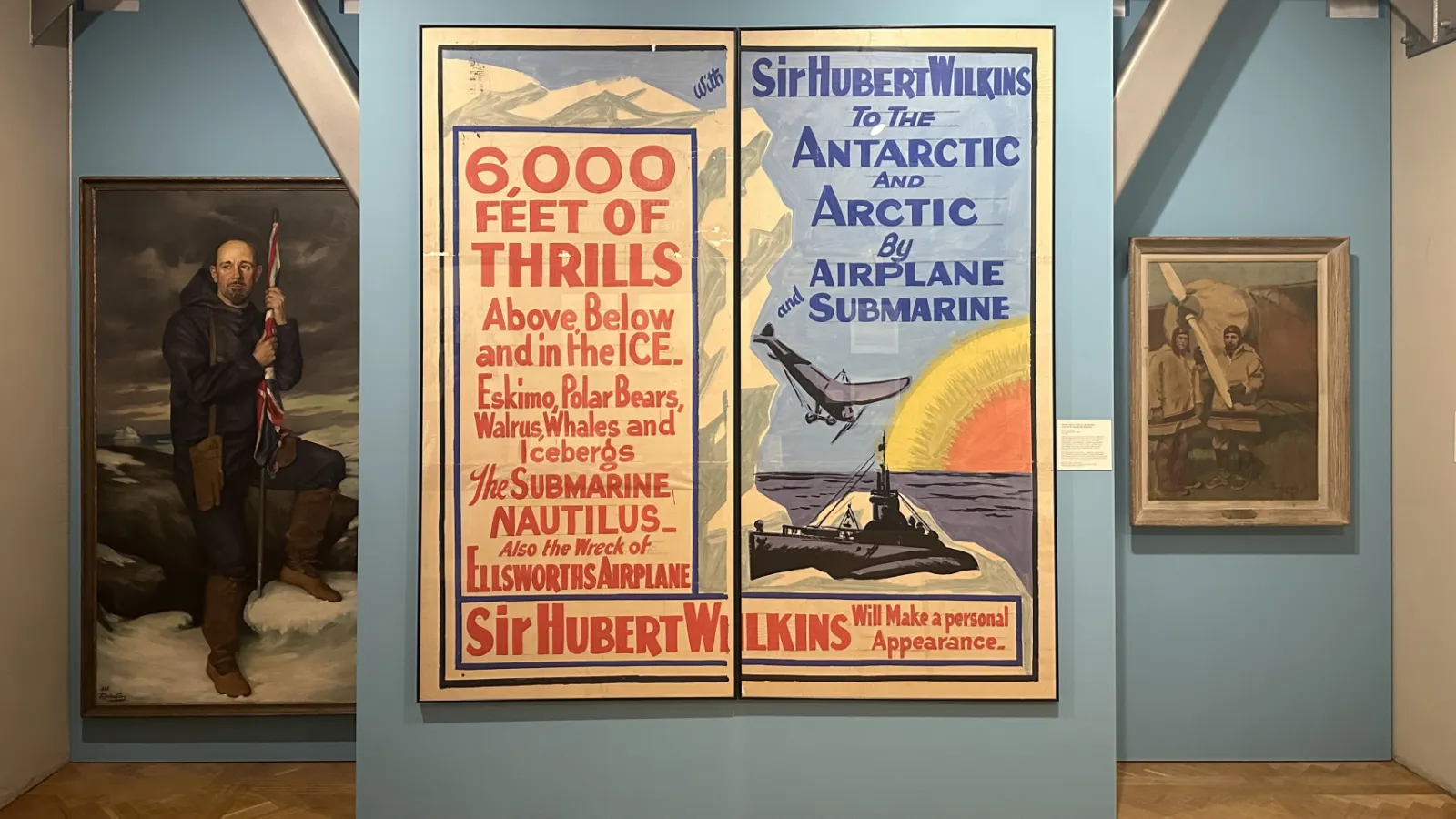 Large poster on teal wall. See caption for specifics.