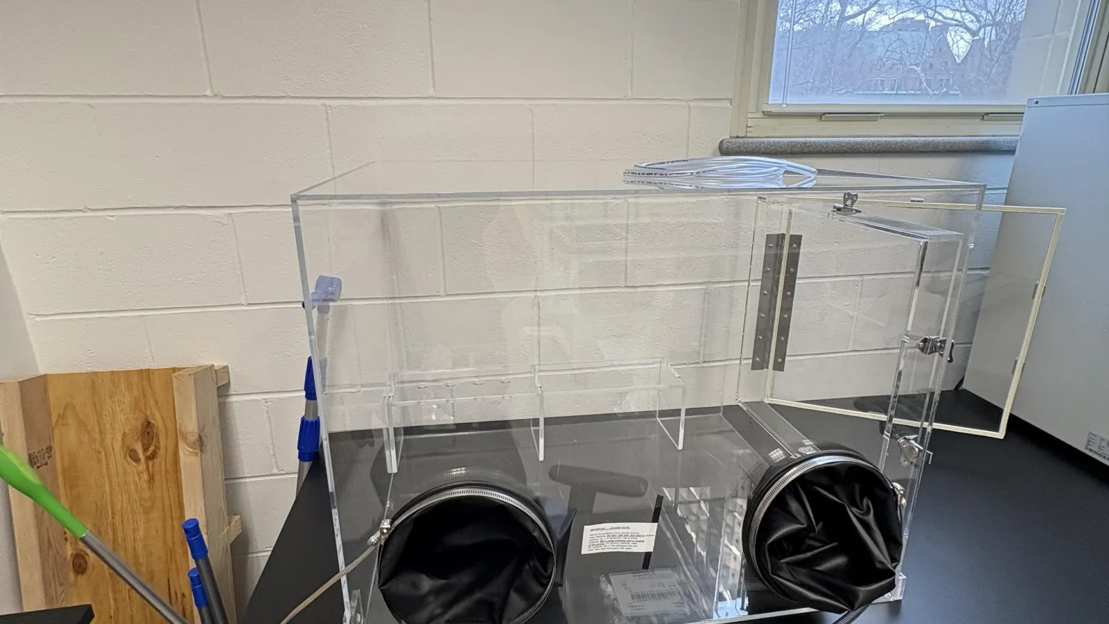Enclosed small clear box with gloves attatched