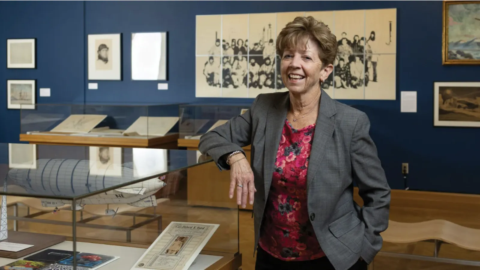 Laura Kissel standing next to a display case in the Polar Expressions exhibit.