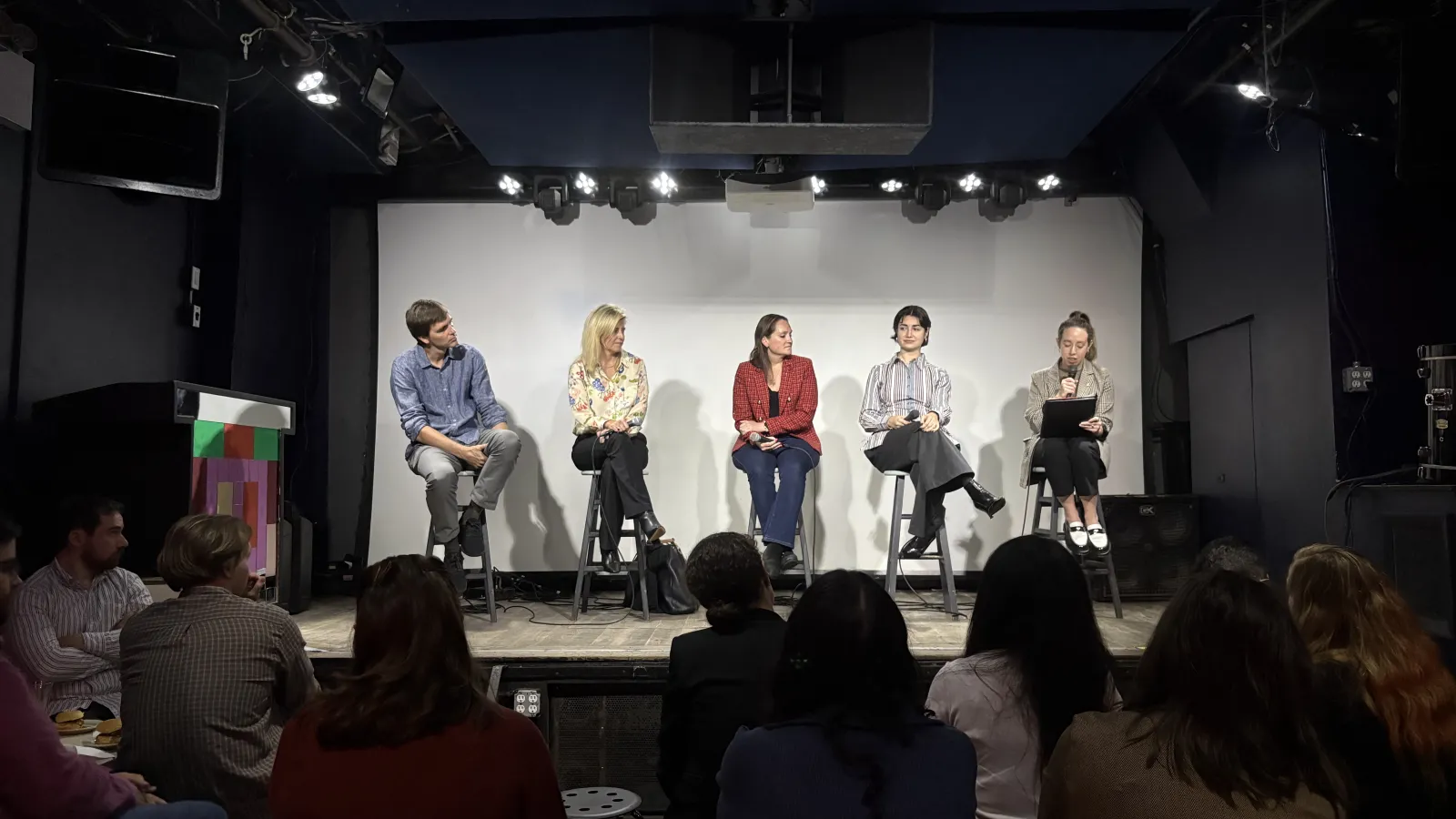 Left to right: Bart Elmore, Shannon Sullivan Roberts, Julie Mansfield, and Bart Elmore sitting on a stage discussing their current professional roles and how they interact with sustainability.
