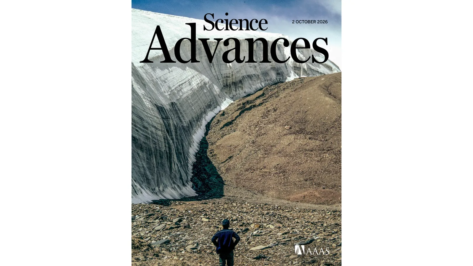 View of the Guliya Ice Cap on the Tibetan Plateau, showing a steep wall of exposed glacial ice beside rocky terrain, with a person standing in the foreground.