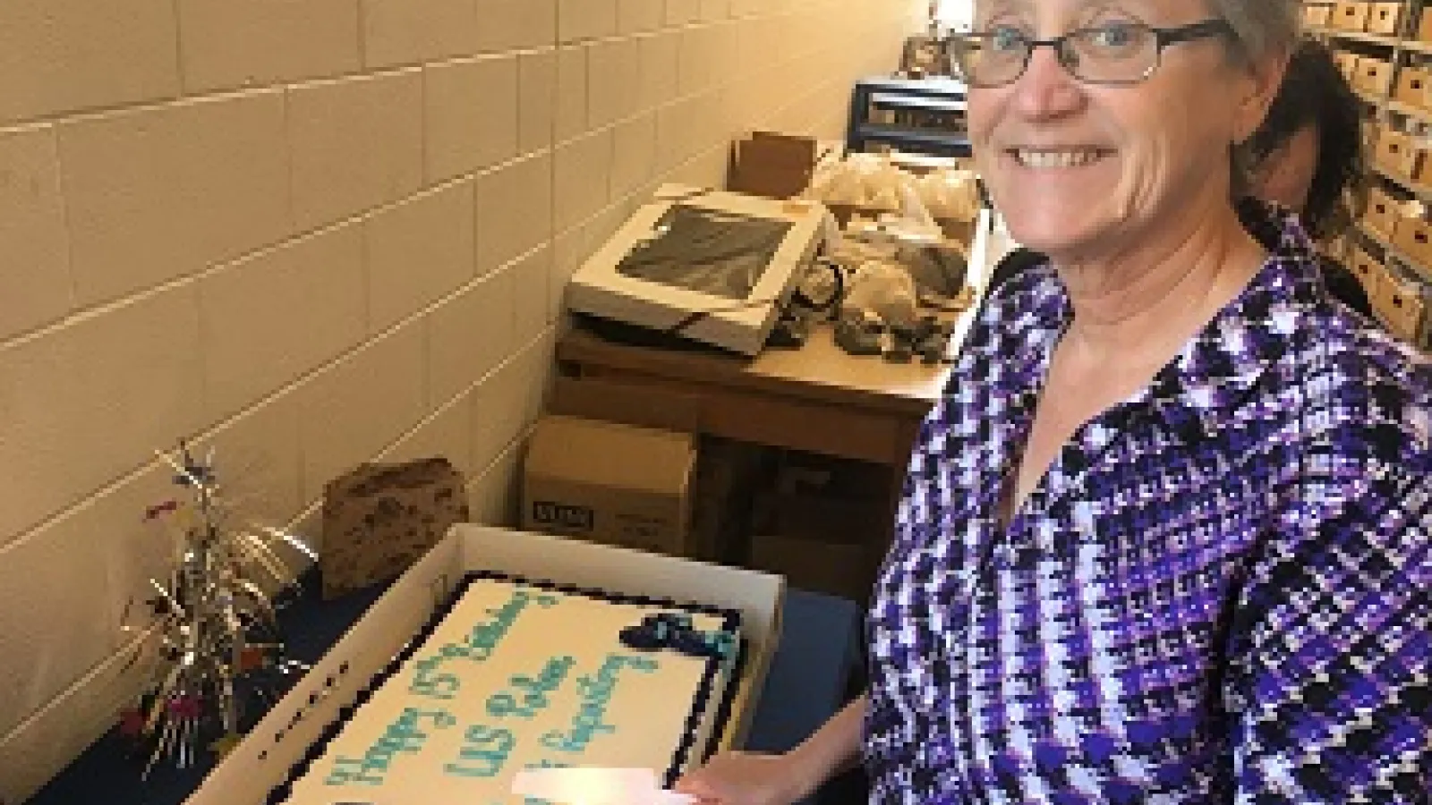 Anne Grunow cutting a birthday cake
