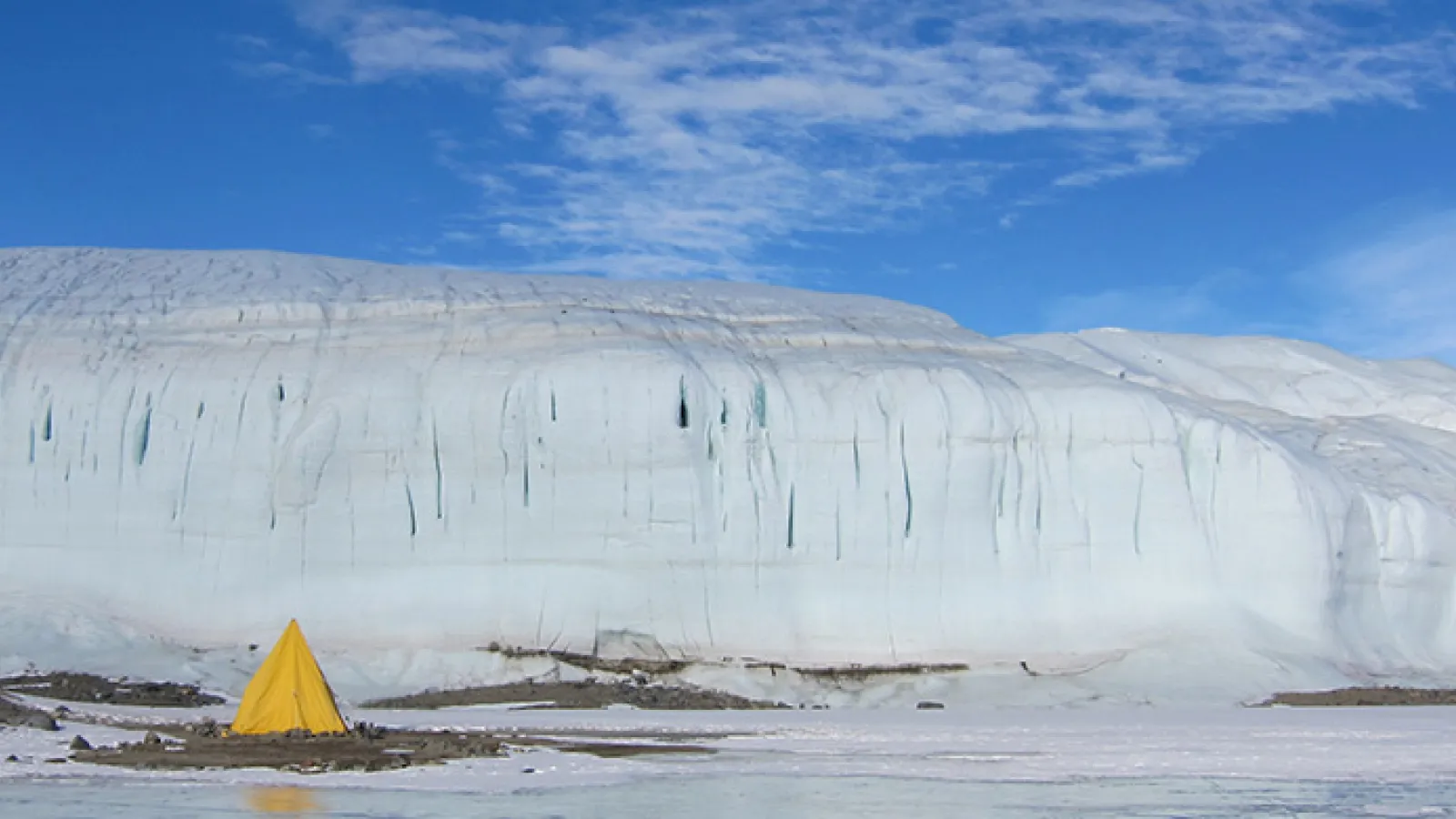 Tent Adjacent to Frozen Lake in Antarctica
