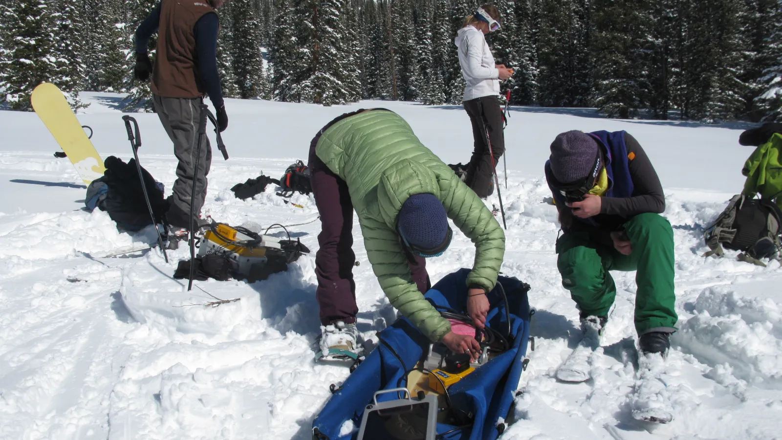 Team of Scientists Assembling Equipment on a Sled