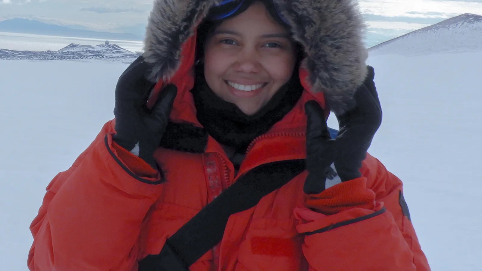 Woman in fur-lined coat with ice sheet backdrop
