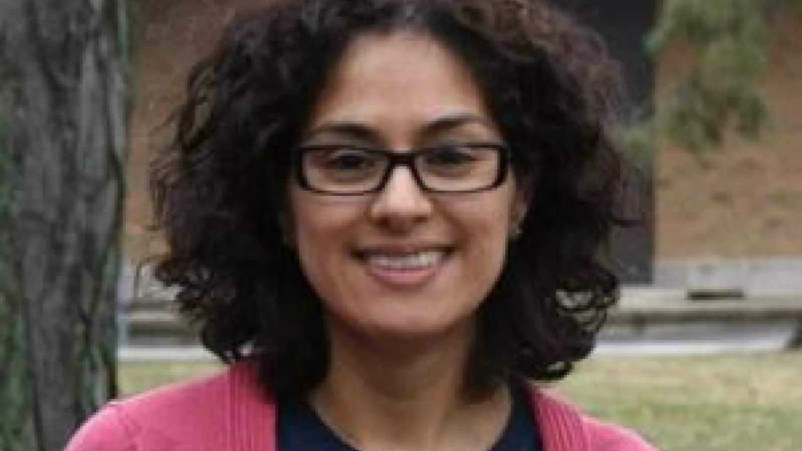 Woman with black hair and pink shirt